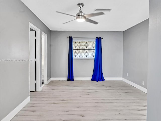 unfurnished room with ceiling fan, plenty of natural light, and light hardwood / wood-style floors