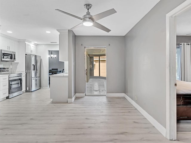 kitchen featuring ceiling fan, stainless steel appliances, light hardwood / wood-style flooring, and white cabinetry