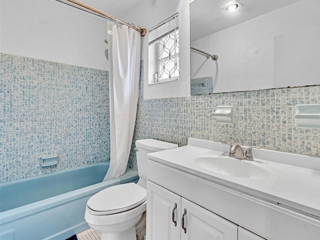 full bathroom with tile patterned floors, shower / tub combo, vanity, tile walls, and toilet