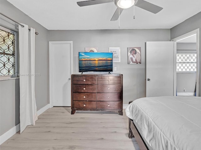 bedroom with ceiling fan and light hardwood / wood-style flooring