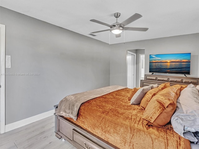 bedroom with ceiling fan and light hardwood / wood-style floors