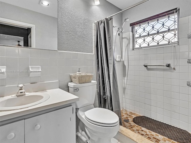 bathroom featuring decorative backsplash, toilet, vanity, tile walls, and curtained shower