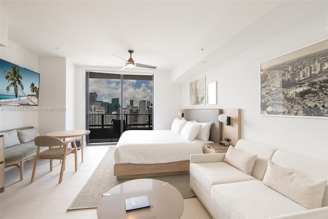 tiled bedroom with ceiling fan and access to outside