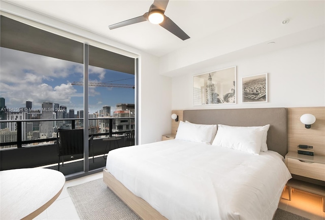 tiled bedroom with ceiling fan and access to exterior