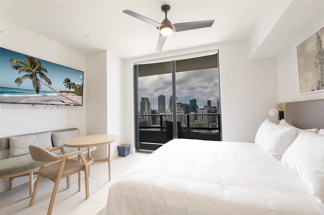 tiled bedroom featuring ceiling fan, access to outside, and a wall of windows