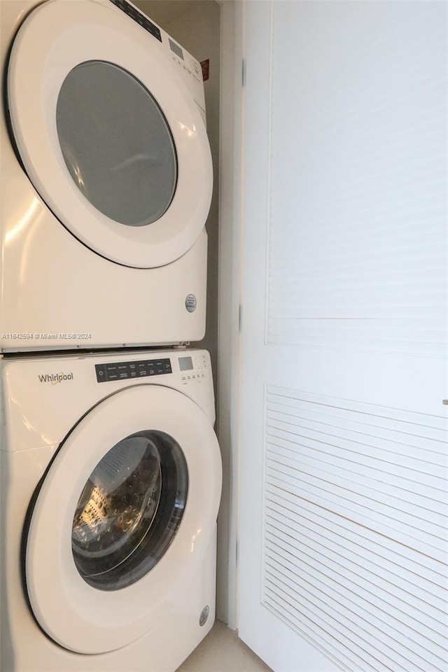 laundry room featuring stacked washer / drying machine