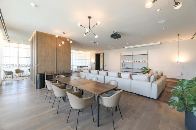 dining area with dark hardwood / wood-style flooring and a chandelier