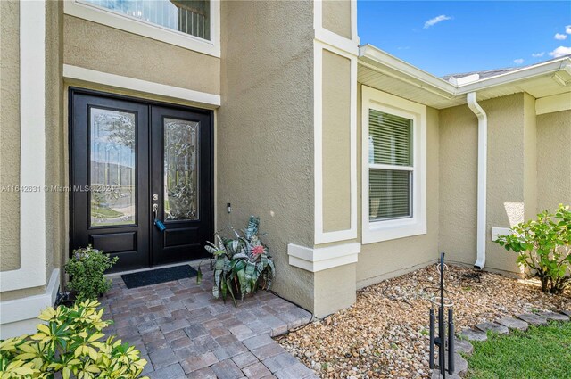 view of exterior entry featuring french doors