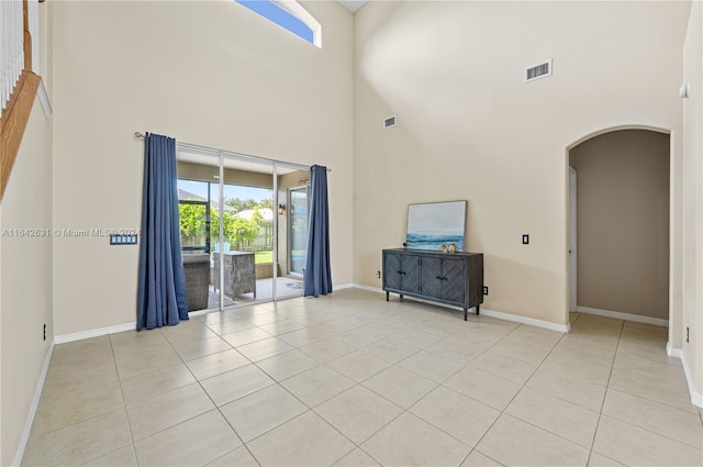 unfurnished living room featuring light tile patterned floors