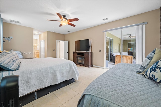 tiled bedroom featuring ceiling fan and connected bathroom