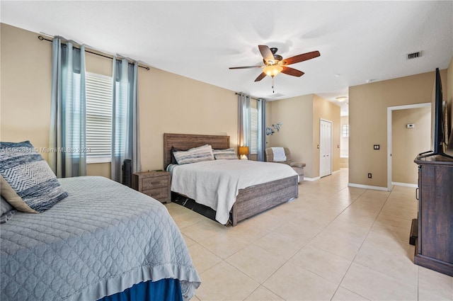 bedroom featuring light tile patterned flooring and ceiling fan