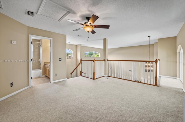 carpeted spare room with a textured ceiling