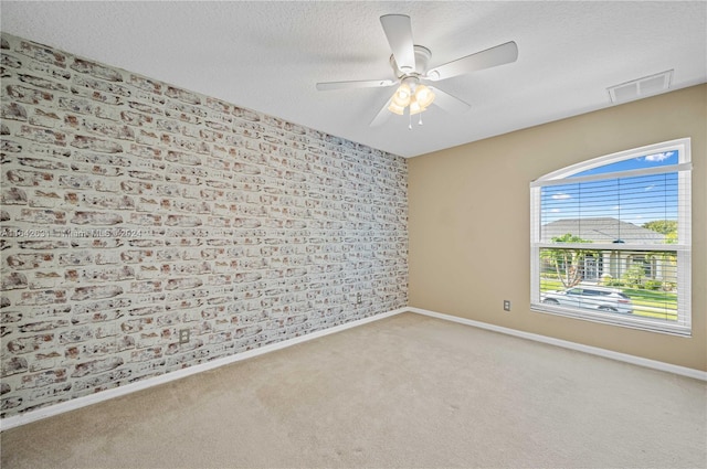 carpeted spare room with ceiling fan and a textured ceiling