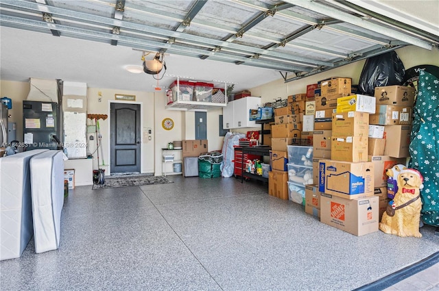 garage with a garage door opener and electric panel