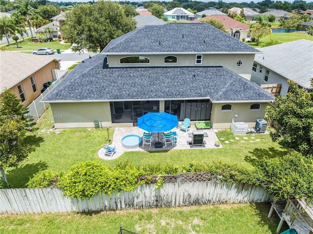 rear view of property featuring a patio, a fire pit, a yard, central air condition unit, and a sunroom