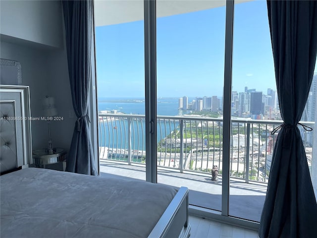 unfurnished bedroom featuring a water view and access to exterior