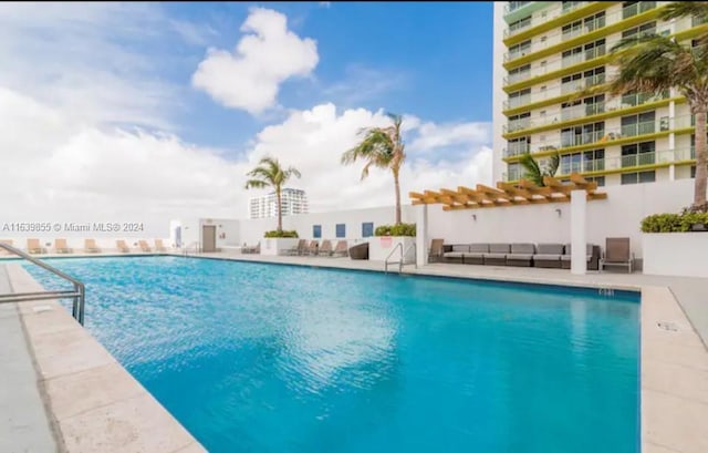 view of swimming pool featuring a patio area and a pergola