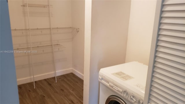 laundry area with dark hardwood / wood-style flooring and washer / clothes dryer