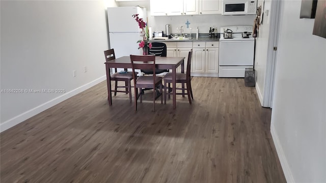 5212 Treetops Dr Unit B-4, Naples, FL 34113 - kitchen with white appliances, dark wood finished floors, white cabinetry, and dark countertops