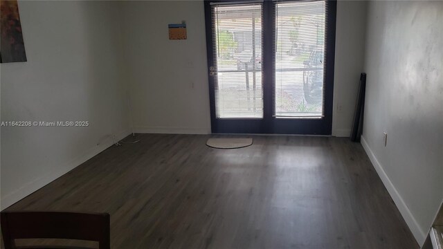 unfurnished room featuring dark hardwood / wood-style floors