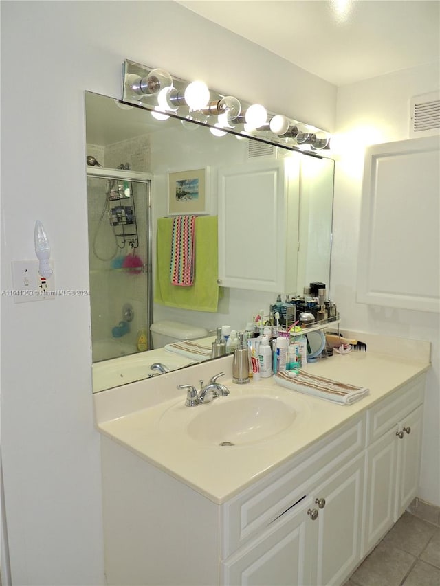 bathroom featuring tile patterned floors, toilet, and vanity