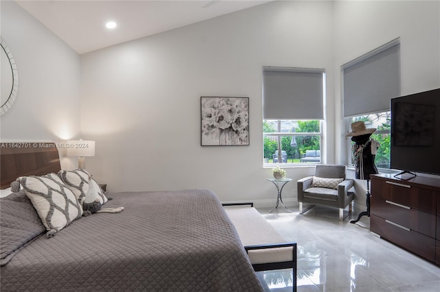 bedroom featuring high vaulted ceiling and light tile patterned floors