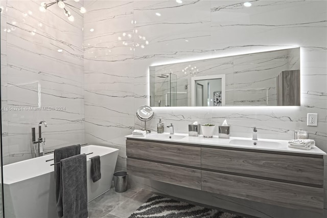 bathroom featuring tile walls, double sink vanity, and tile patterned floors