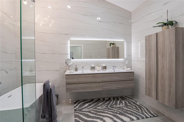 bathroom with tile walls, tile patterned floors, and dual vanity