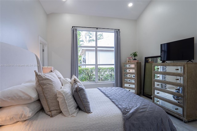 bedroom featuring vaulted ceiling and multiple windows