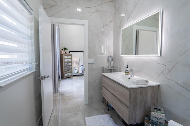 bathroom featuring tile walls, vanity, and tile patterned floors