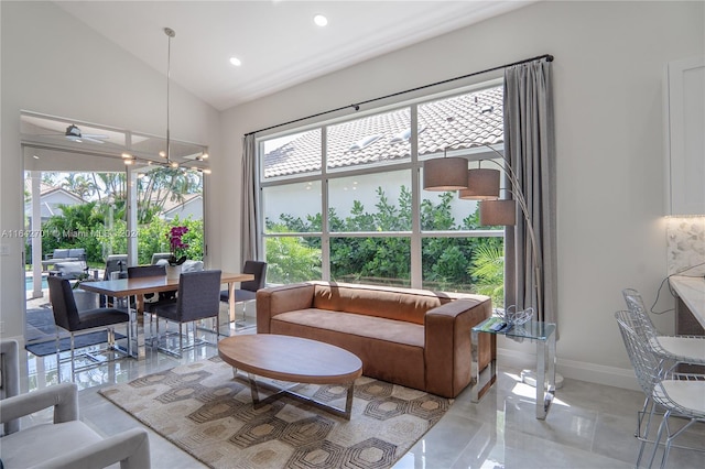 tiled living room with high vaulted ceiling and ceiling fan