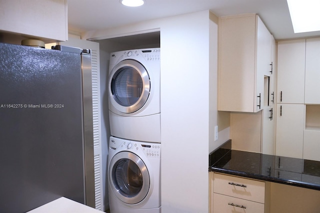 laundry area featuring stacked washing maching and dryer