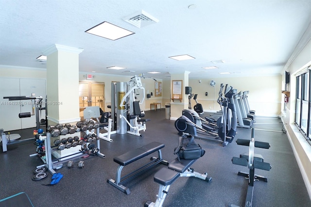 workout area featuring crown molding