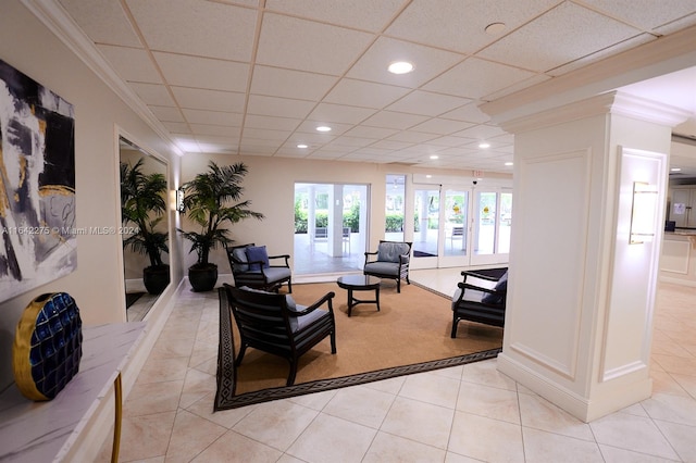 tiled living room featuring crown molding, a paneled ceiling, and french doors