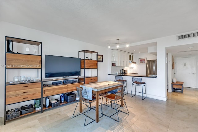 dining room with light tile patterned floors and sink