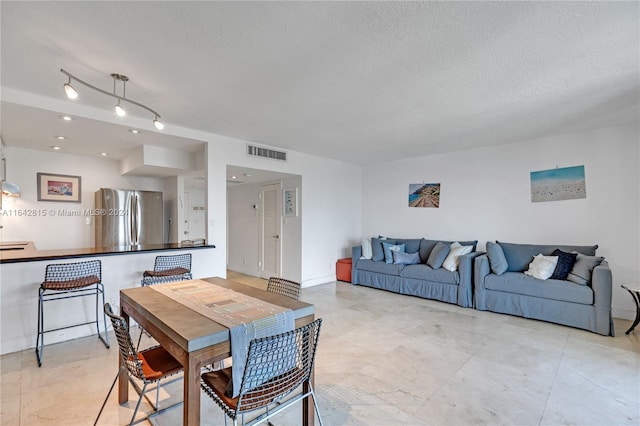 dining area featuring a textured ceiling