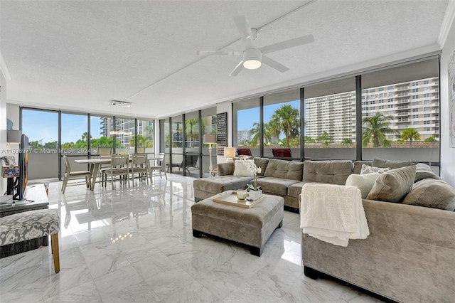 living room featuring ornamental molding, a textured ceiling, floor to ceiling windows, and ceiling fan