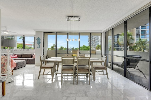 dining space featuring a textured ceiling and ceiling fan