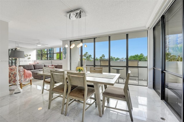 dining area with a textured ceiling, floor to ceiling windows, and ceiling fan