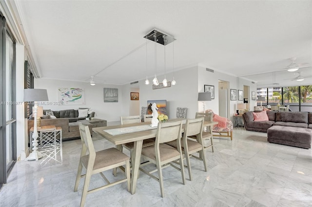 dining area with crown molding and ceiling fan