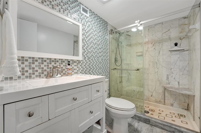 bathroom featuring toilet, a shower with door, vanity, decorative backsplash, and tile walls