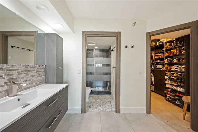 bathroom with an enclosed shower, tile patterned flooring, vanity, and tasteful backsplash