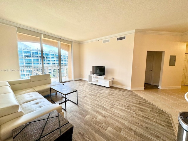 living room with hardwood / wood-style floors, crown molding, a textured ceiling, and electric panel