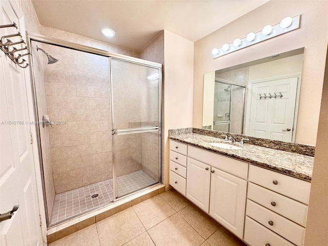 bathroom featuring vanity, tile patterned floors, and walk in shower