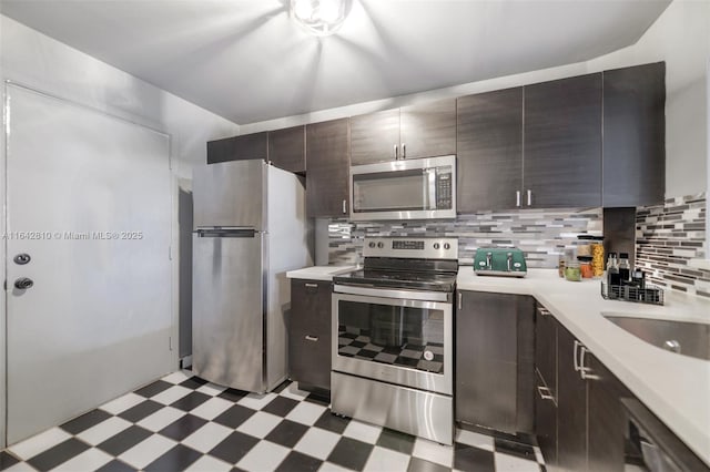 kitchen with decorative backsplash, sink, dark brown cabinetry, and stainless steel appliances