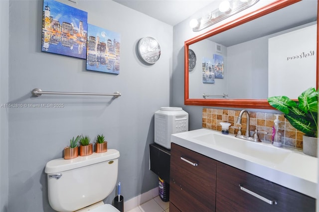 bathroom with tile patterned flooring, decorative backsplash, toilet, and vanity