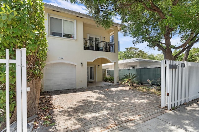 view of front of house featuring a balcony and a garage