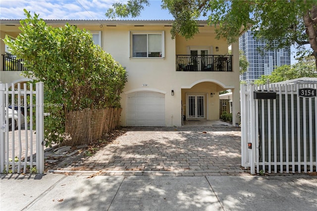 view of front of house with a garage and a balcony