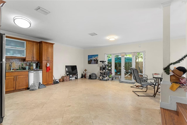 interior space with light tile patterned floors, ornamental molding, and french doors