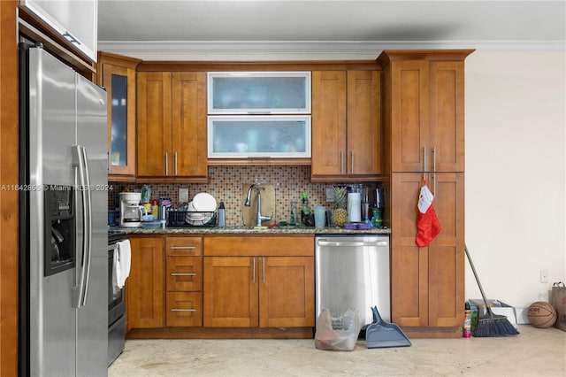 kitchen featuring backsplash, stainless steel appliances, sink, light tile patterned floors, and dark stone counters